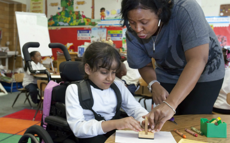 Teacher and child in wheelchair