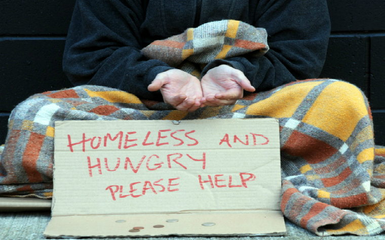 Description_of_image_used_in_homelessness_guide_homeless_person_hungry_sign